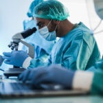 Image representing scientists entering data on laptop used by Diskover in association with the Diskover Life Science Edition. The NIH issued a new Data Management and Sharing Policy (DMS) in January 2023 and Diskover has the tools to assist with meeting the NIH DMS requirements.