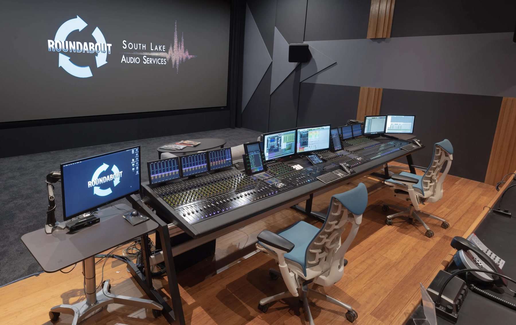 Audio mixing stage at Roundabout, with the company logo on the screen and a large mixing console running session windows